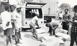 Men lifting bags